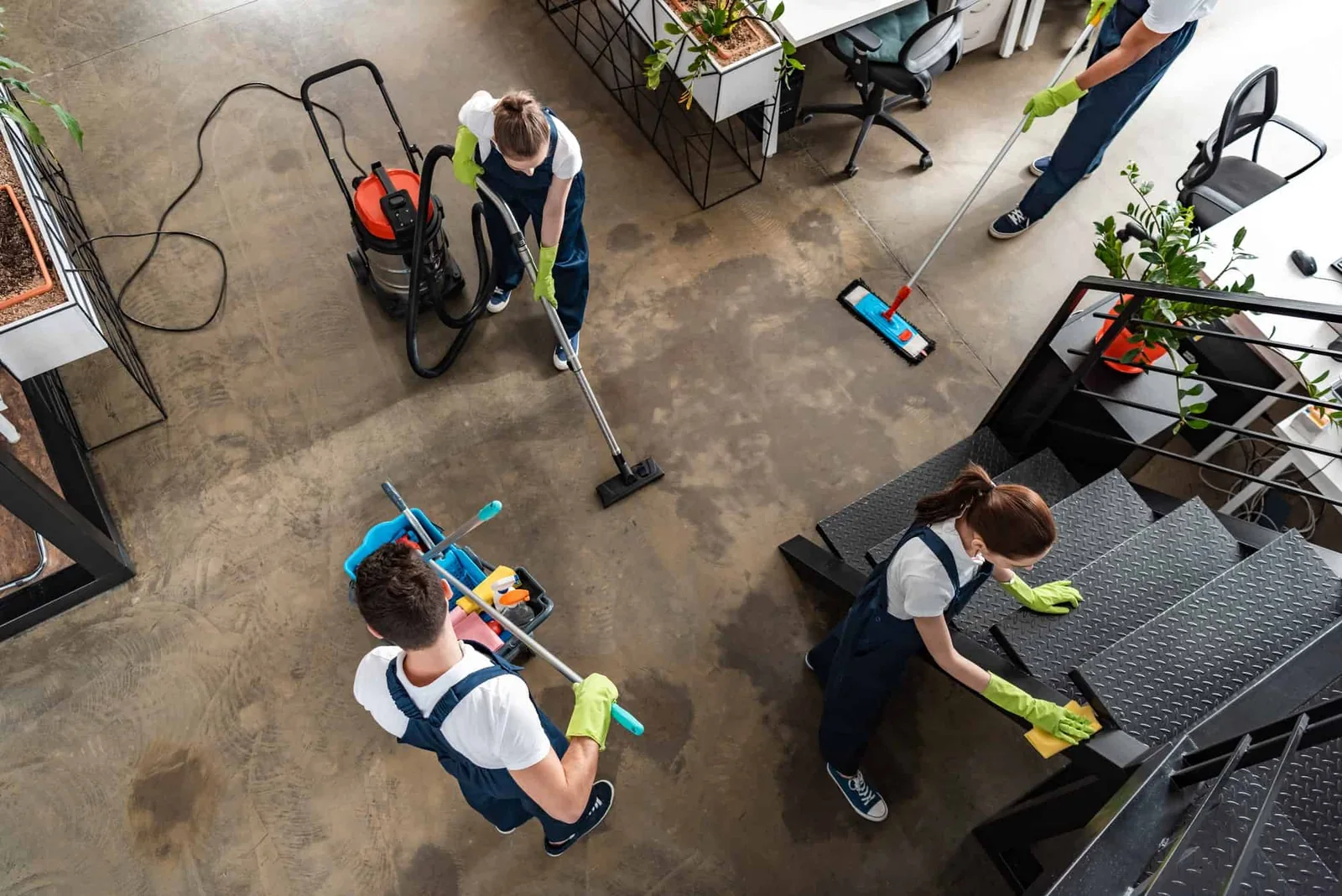 A cleaning team tidying a modern interior.