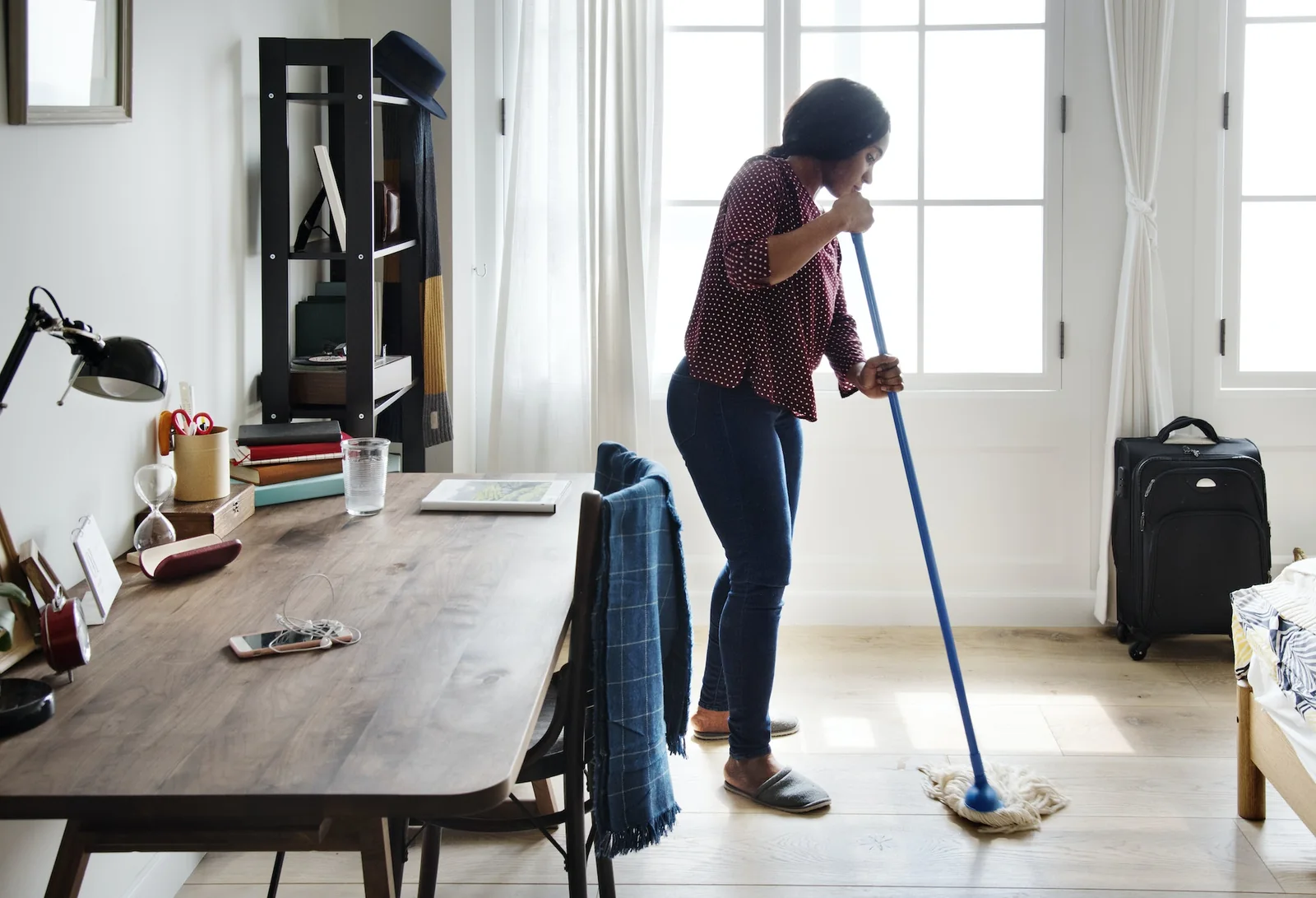 A cleaner working in a bright living space.